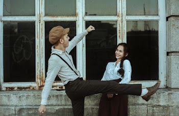 Couple Standing Beside Window