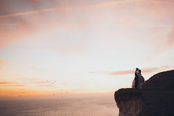 Couple Standing By The Cliff
