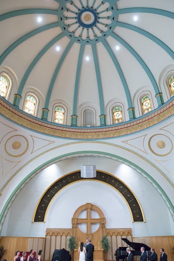 Couple Standing in Front of Altar and Priest