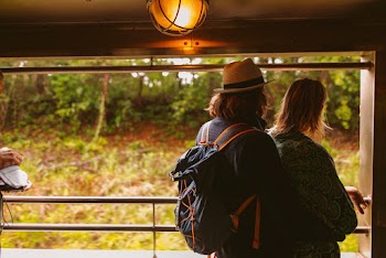 Couple Standing In Front of Plants and Trees