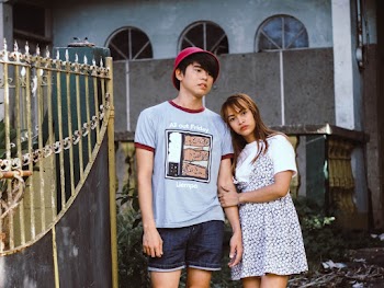 Couple Standing Near Gray Metal Gate