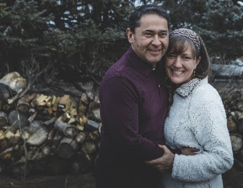 Couple Standing Near Pile of Firewoods