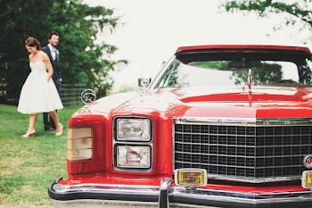 Couple Standing Near Red Classic Monte Carlo