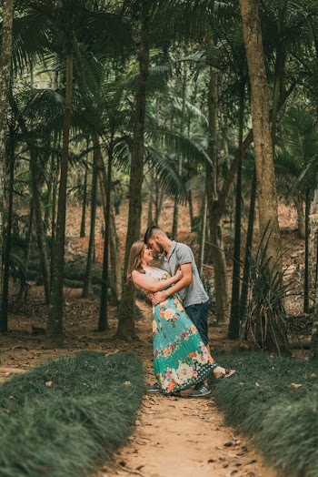 Couple Standing on Dirt Road Surrounded by Trees
