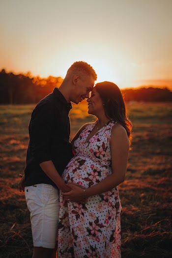 Couple Standing on Grass Field
