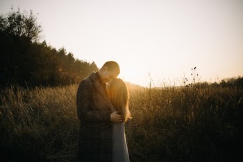 Couple Standing on Plant Field during Golden Hour