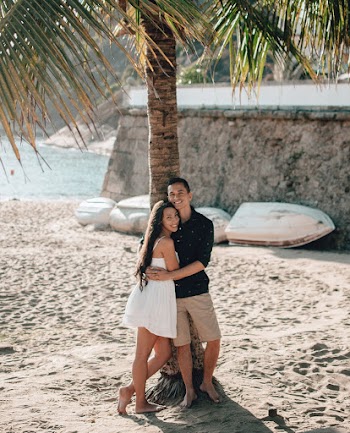 Couple Standing Under Tree