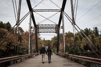 Couple Walking on Gray Bridge at Daytime