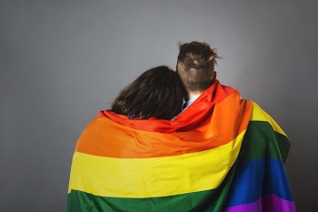 Couple Wrapped In Pride Flag