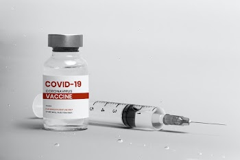 COVID-19 vaccine injection glass bottle with syringe