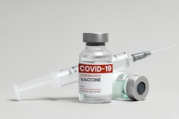 COVID-19 vaccine injection glass vial with syringe