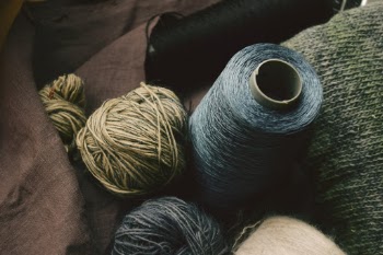 Craft knitting supplies with silk fibre coils and wool threads.