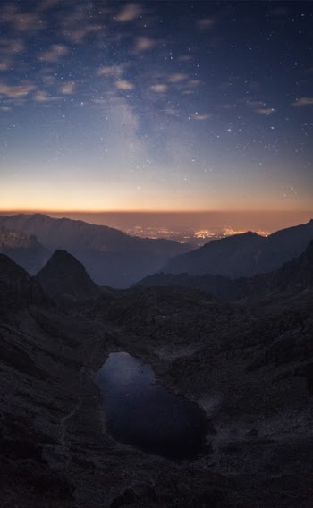 Crater Between Mountains Under Blue Sky White Clouds and Stars during Sunset