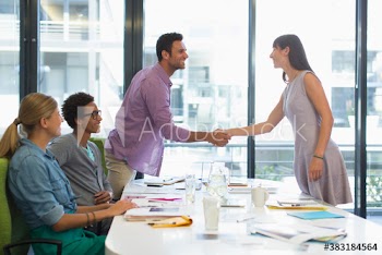 Creative business people shaking hands in conference room meeting