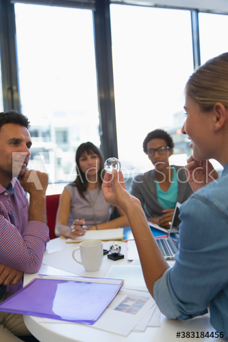 Creative business people with crystal orb in conference room meeting