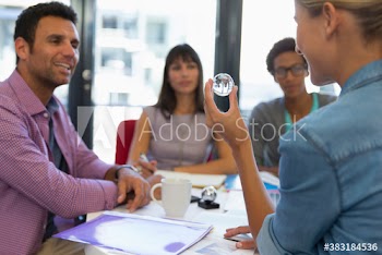 Creative business people with crystal orb in conference room meeting