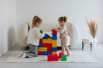 Creative Playtime: Children Building with Colorful Blocks