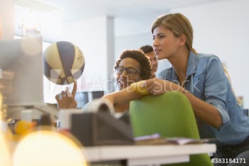 Creative young business people at laptop in office