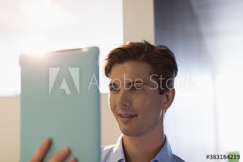 Creative young businessman using digital tablet