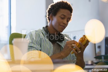 Creative young businessman with headphones brainstorming in office