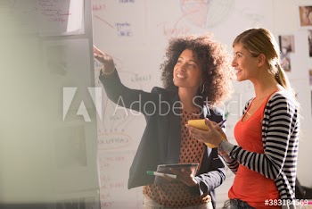 Creative young businesswomen brainstorming in office