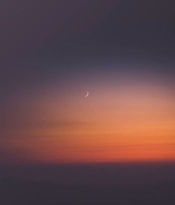 crescent moon during sunset