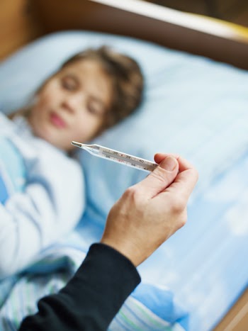 cropped view of woman taking temperature of her daughter. Selective focus
