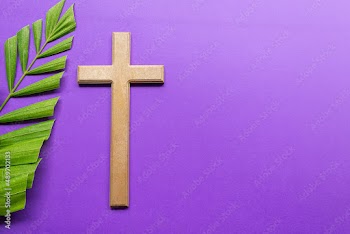 Cross and palm leaves on purple background. Lent season concept.