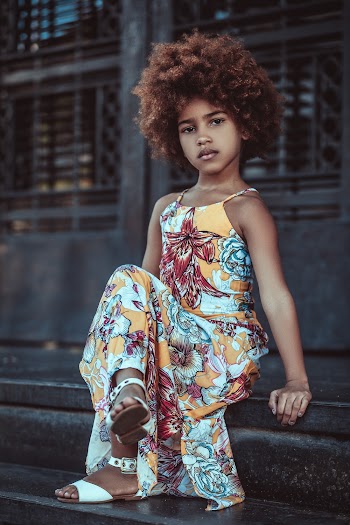 Crossed Leg Girl Sitting on Stairs and Looking at the Camera