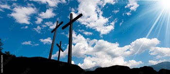 Crosses Silhouette against Blue Sky / Silhouette of three crosses against a blue sky with clouds and sun rays. Carisolo Trentino Italy