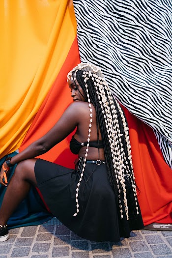 Crouching Woman Wearing Black Bra and Black Skirt