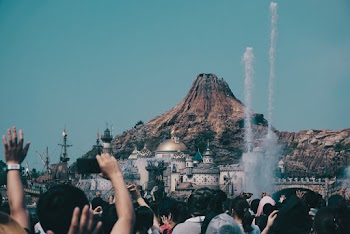 Crowd in Front of Building With White Smokes