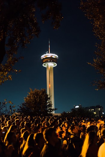 Crowd of People Standing Outside during Night Time