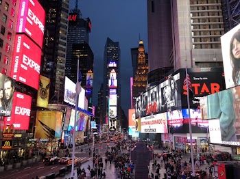 Crowd Walking Between Lighted Buildings during Nighttime