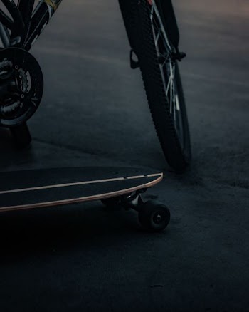 cruiser board beside bicycle