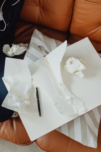 Crumpled Papers and Notebook with Torn Pages