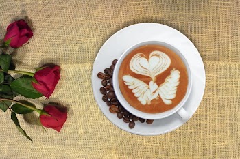 Cup of Coffee in Distance With Red Rose