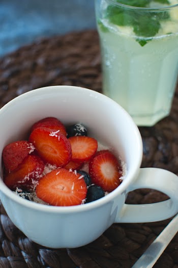 Cup of oatmeal with berries and coconut 