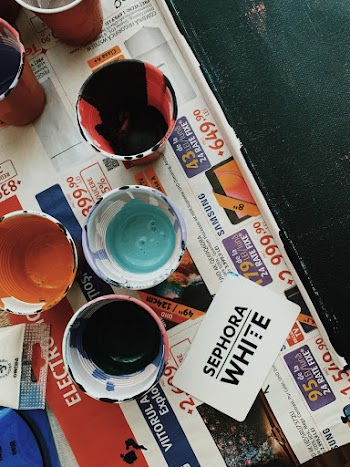 Cups With Assorted-color Paints on Newspaper