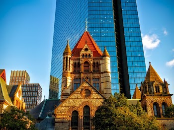 Curtain-wall Building Behind Red and Beige Concrete Cathedral