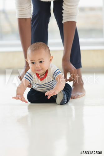 Cute baby boy crawling on floor