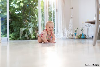 Cute baby girl crawling on floor