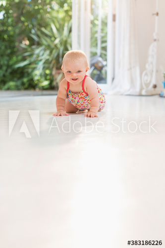 Cute baby girl crawling on floor