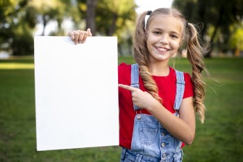Cute girl holding empty banner in her hand Free Photo