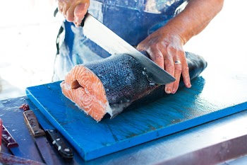 Cutting fresh caught salmon 