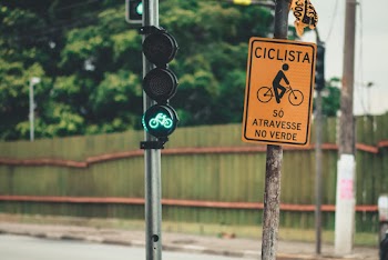 Cyclist Sign Near Traffic Light in Green Light
