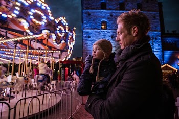 Dad And daughter Watching Carousel