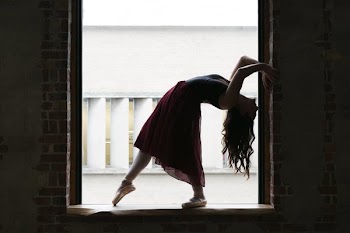 Dancer Bends Back In Window