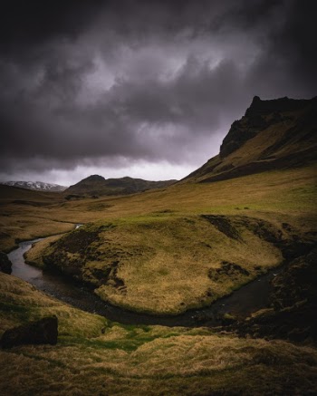 Dark skies over a river bend in Iceland. 
