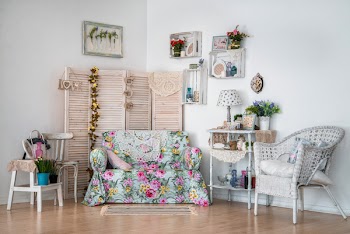 Decor in the style of Provence, turquoise sofa, white wicker chair, wooden screen